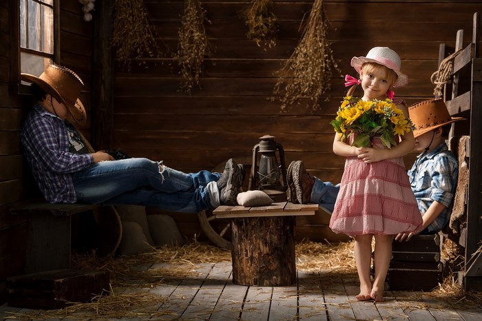 Children in cowboy hats with sunflowers
