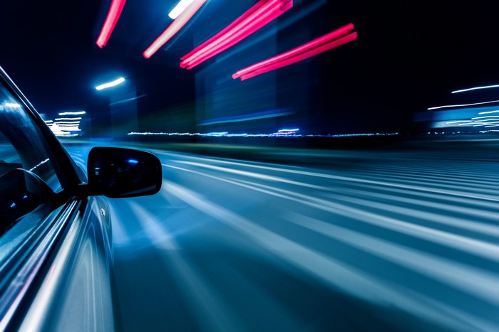 Car driving at night with motion blur