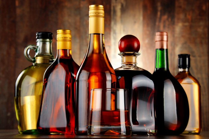 Bottles of Alcohol and a Glass