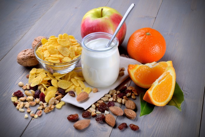 Still-life of breakfast with yogurt, fruit, and nuts