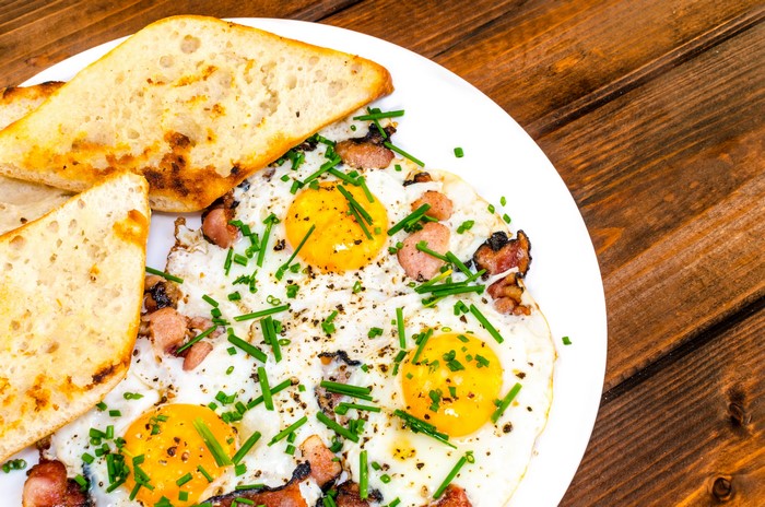 Fried eggs with bacon and toast