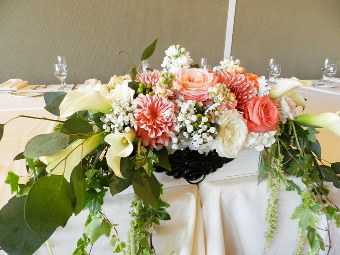Floral arrangement with roses, dahlias, and calla lilies