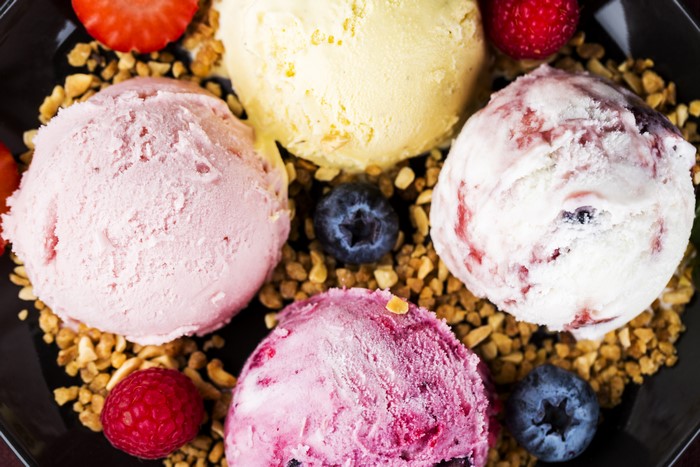 Ice cream scoops with berries and nuts
