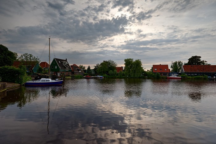 Houses and boats on a river in Nauerna, Netherlands