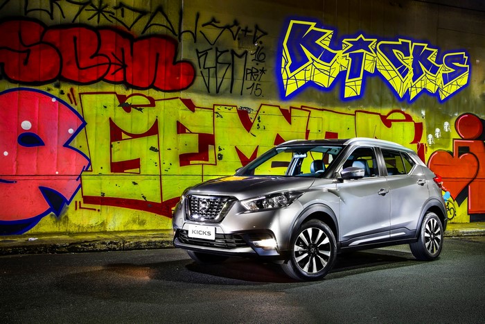 Silver 2016 Nissan Kicks parked in front of graffiti wall
