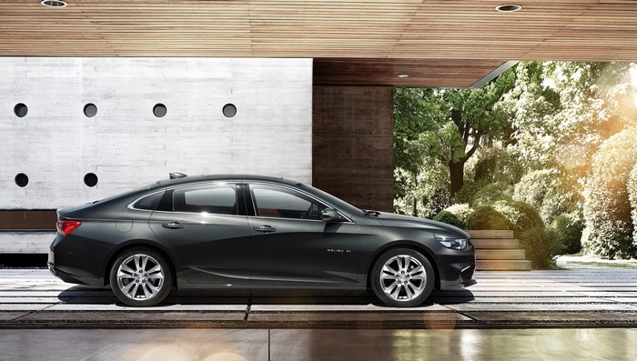 Chevrolet Malibu XL parked in modern architectural setting