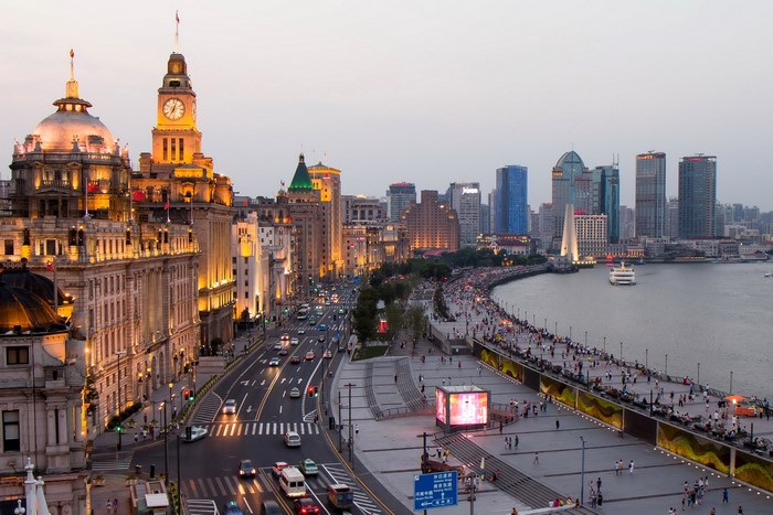 Shanghai Bund waterfront at dusk with traffic and skyscrapers
