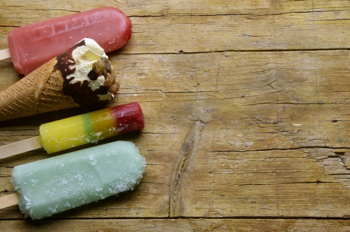 Assortment of ice cream and popsicles on a wooden surface