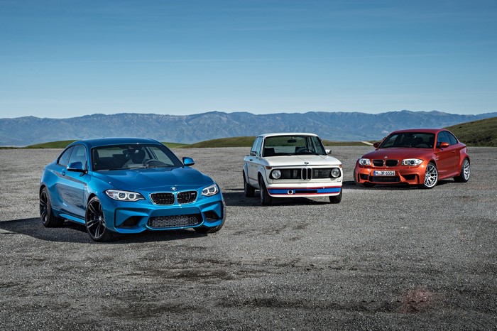 Three BMW cars: blue, white, and orange