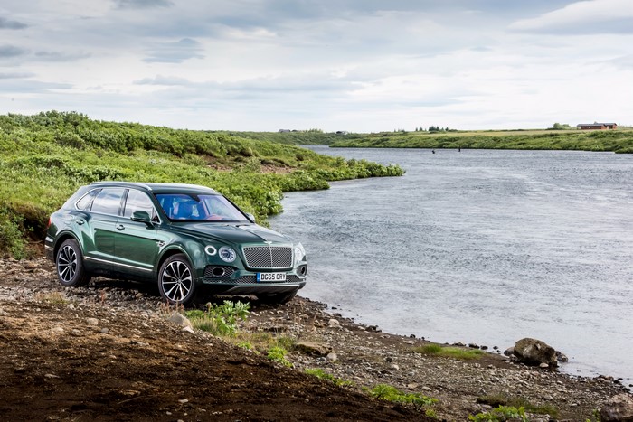 Green Bentley Bentayga by a River