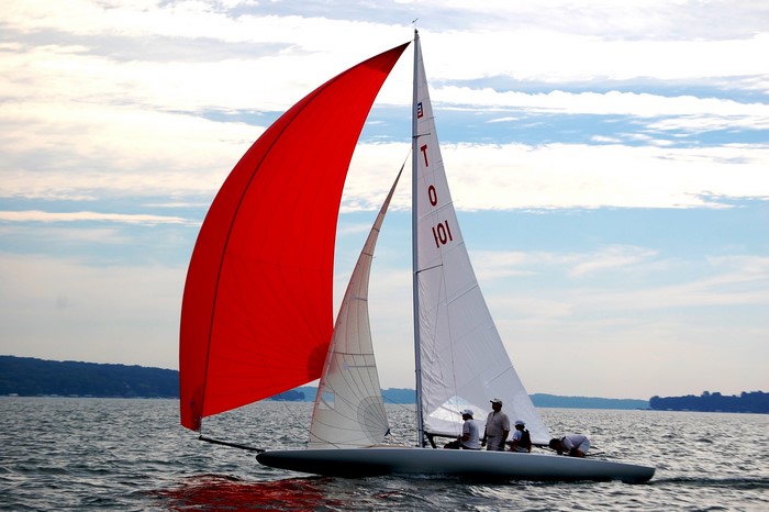 Sailboat with red and white sails on the water