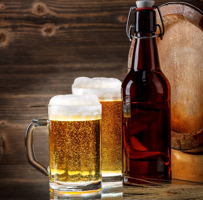 Beer in mug and bottle with barrel