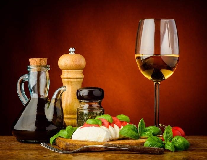 Still life of Caprese salad with wine and olive oil