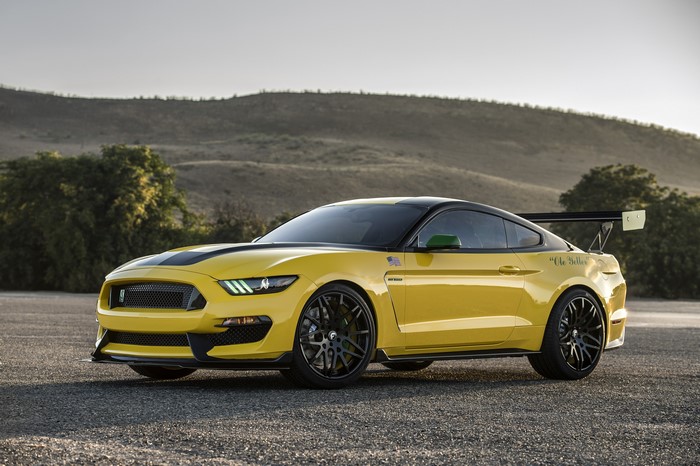 Yellow Ford Shelby Mustang GT350 with a large rear spoiler