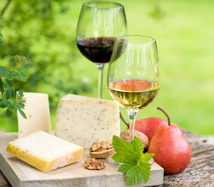Wine, Cheese, Pears, and Nuts on a Wooden Table