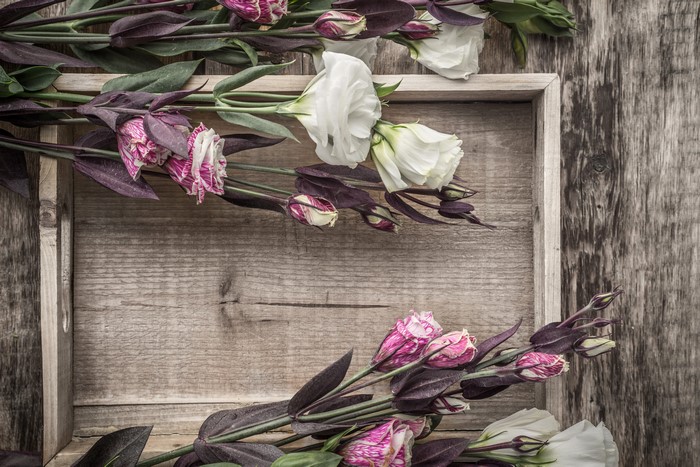 Eustoma flowers in a wooden tray