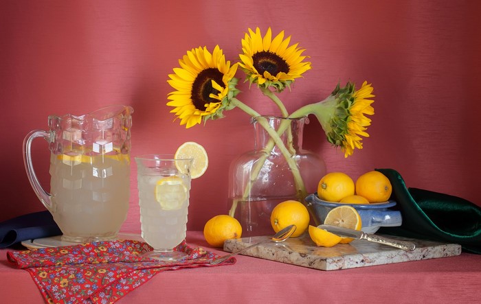 Still life with sunflowers, lemons, and lemonade