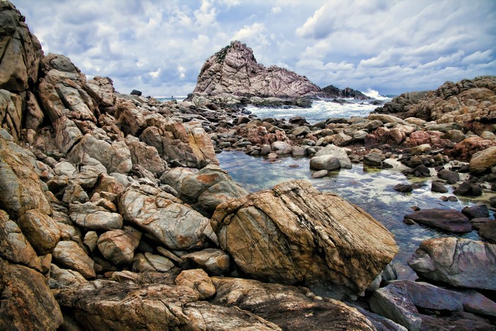 Rocky coastline with large rock formation in the ocean