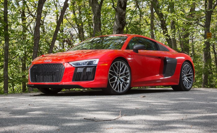 Red Audi R8 V10 Plus parked in a forest