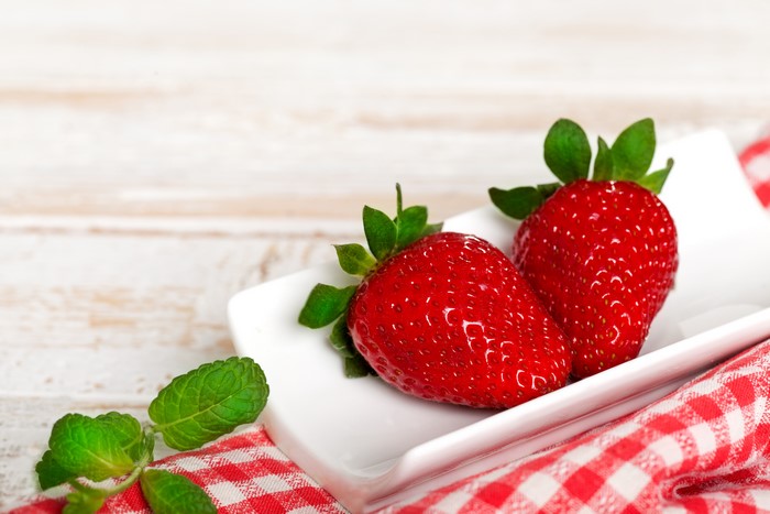 Two Strawberries on a Plate with Mint