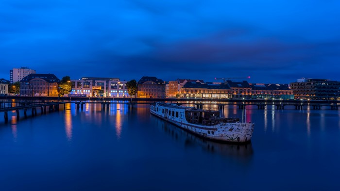 Abandoned ship on a river at night in Berlin