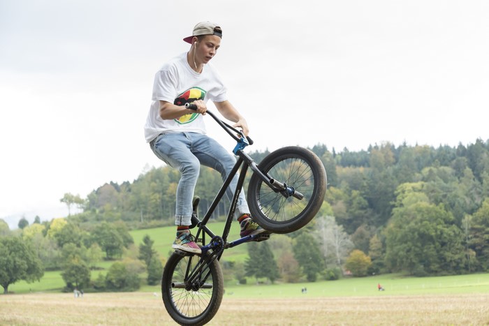Young man on a BMX bicycle performing a trick