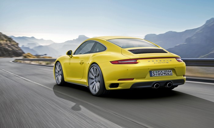Yellow 2015 Porsche 911 Carrera 4S Coupe driving on road