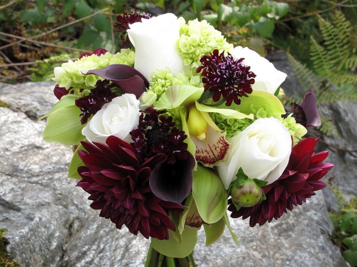 Wedding bouquet with roses, dahlias, callas, and orchids