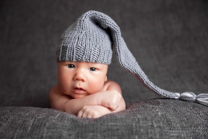 Infant wearing a gray winter hat