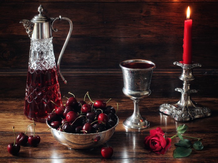 Still-life with cherries, wine, and a candle