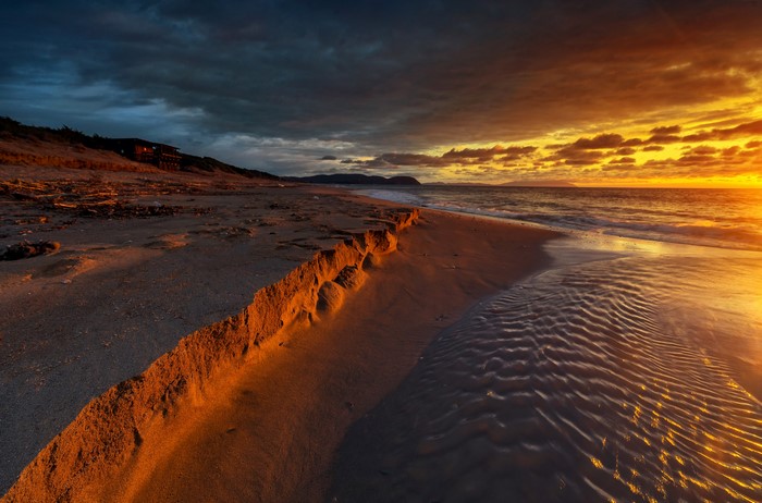 Beach at sunset with dramatic clouds