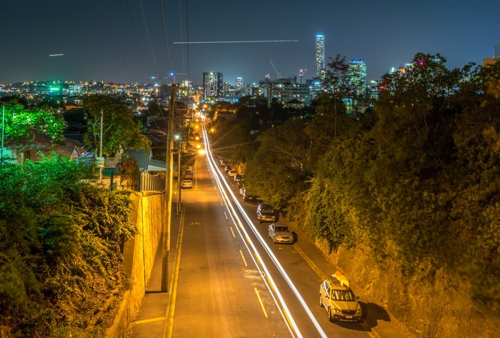 Brisbane Cityscape at Night with Light Trails on Road