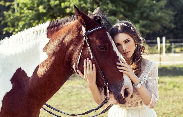 Woman in white dress with horse