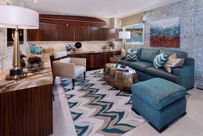 Living room with sofa, armchair, and surfboard decor