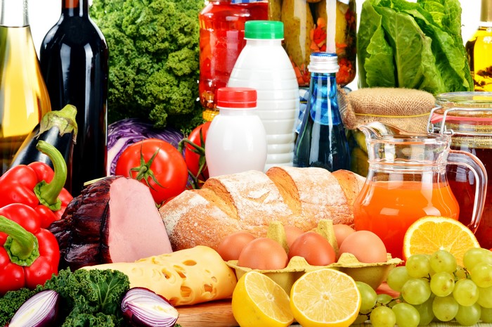 Assortment of Food: Ham, Bread, Cheese, Eggs, Juice, and Produce