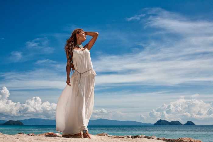 Woman in white dress on a beach