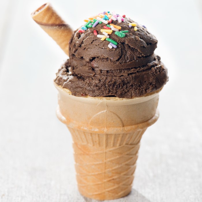 Chocolate ice cream cone with sprinkles and wafer stick