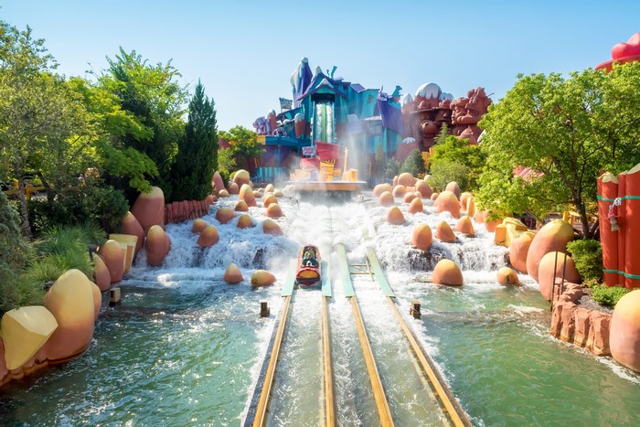 Theme park water ride with colorful structures and a raft