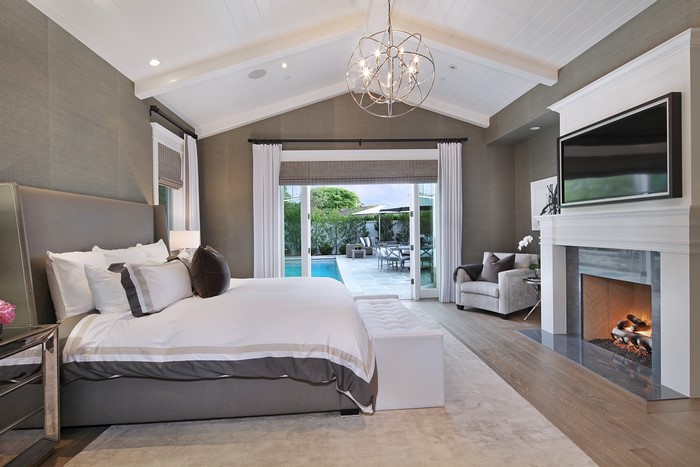 Bedroom with bed, chandelier, and fireplace