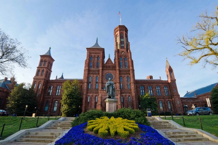 Smithsonian Castle in Washington D.C. with statue and garden
