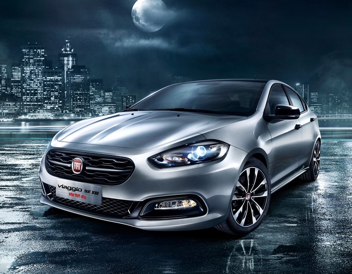 Silver Fiat Viaggio on Wet City Street at Night