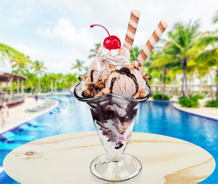 Ice cream sundae with cherry and wafer sticks