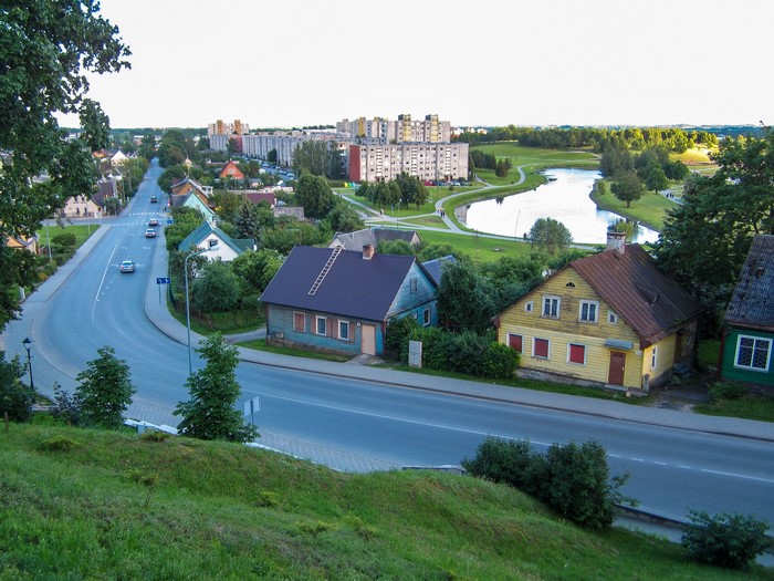 Telsiai, Lithuania: Houses along a road with a pond and apartment buildings