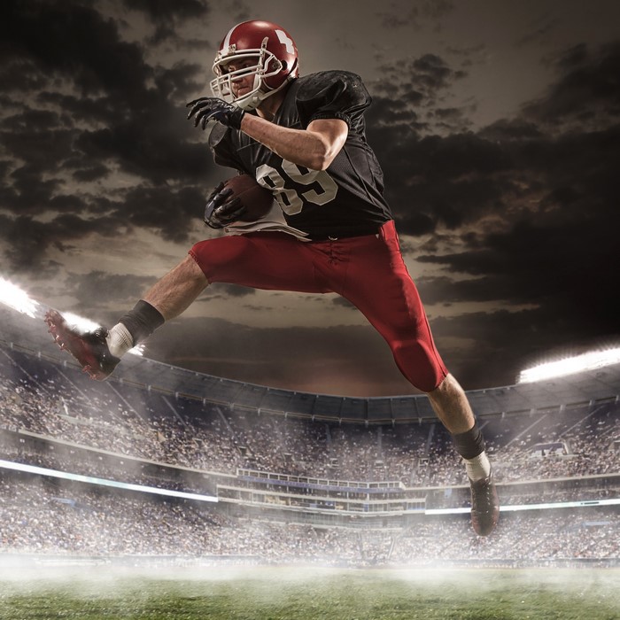 American football player in uniform jumping