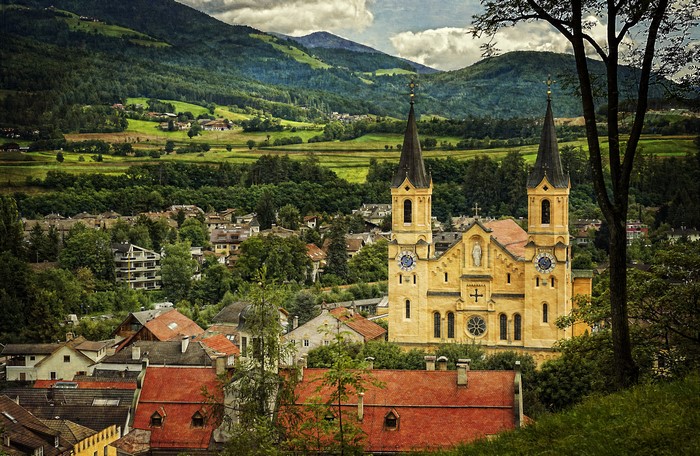 4K Church in Brunico, Italy with Mountains and Forests
