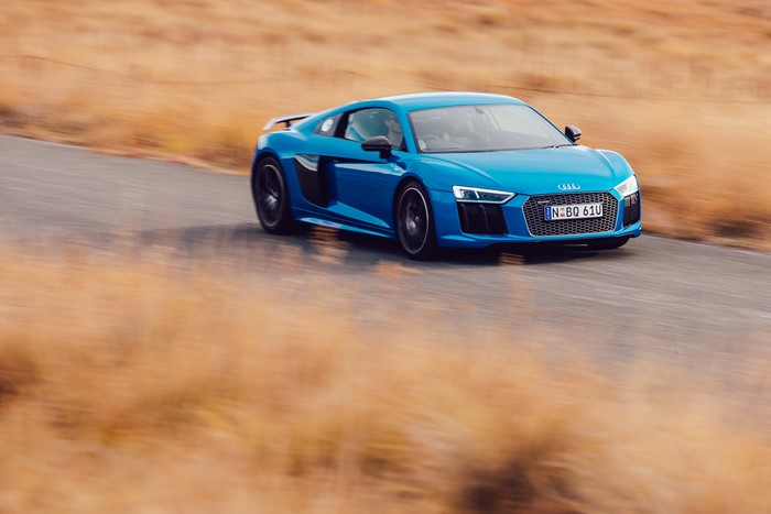 Audi R8 V10 Plus driving on a road
