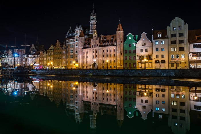 Gdańsk waterfront at night with reflections