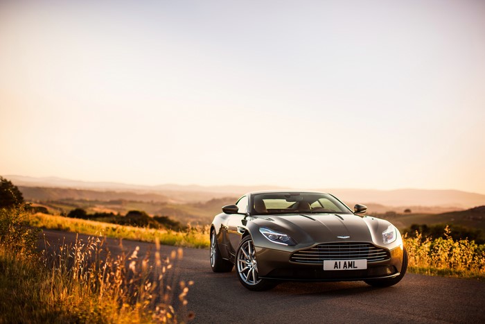 Aston Martin DB11 on a road at sunset