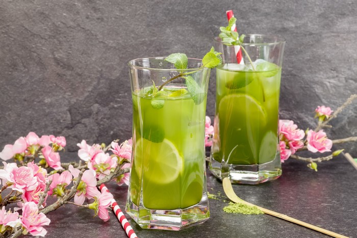 Two matcha drinks with lime and mint