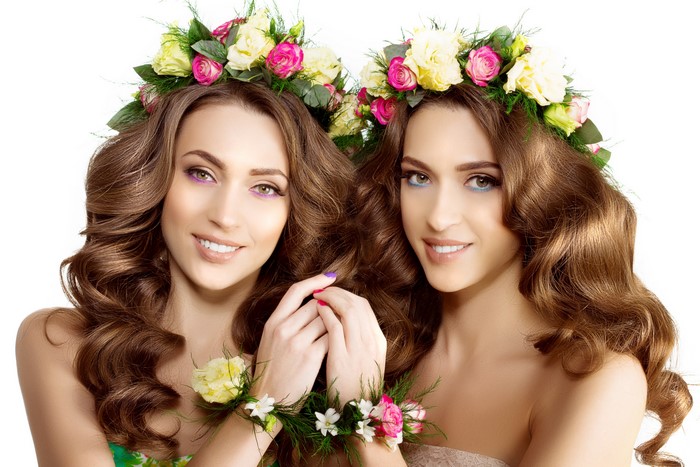 Two brown-haired women with flower crowns